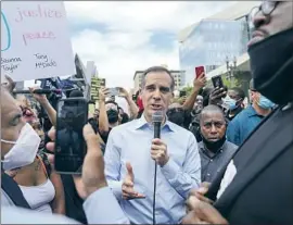  ?? Kent Nishimura Los Angeles Times ?? MAYOR Eric Garcetti, marching with protesters this month near City Hall, is receiving pushback previously unseen during his seven years leading Los Angeles.