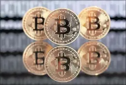  ?? PHOTO: BLOOMBERG ?? A collection of bitcoin tokens. According to Market and Markets, the blockchain technology market size will be worth $2.3bn by 2021.