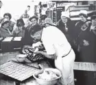  ?? PHOTO: SUPPLIED ?? From the archives . . . A tour group watches Kevin Greaney working at Peter Pan Bakery and Cafe.