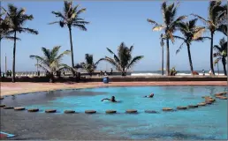  ?? PICTURE: GCINA NDWALANE ?? SANDY SWIM: Sand dumped by the weekend’s waves in a paddling pool at Wedge Beach where children cooled off in this week’s heat.