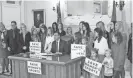  ?? DOUG HOKE/THE OKLAHOMAN ?? Gov. Kevin Stitt signs Senate Bill 2, which bans transgende­r women from competing in women’s sports at Oklahoma schools, during a ceremony Wednesday at the state Capitol.