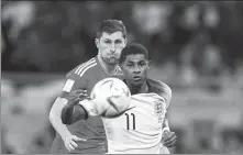  ?? AP ?? Marcus Rashford (right) and Ben Davies of Wales battle for the ball during the World Cup Group B match at the Ahmad Bin Ali Stadium in Al Rayyan, Qatar, on Tuesday.