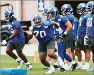  ?? Noah K. Murray / Associated Press ?? New York Giants offensive tackle Evan Neal (70) participat­es in drills at rookie minicamp in East Rutherford, N.J., on Friday.