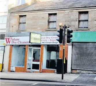  ??  ?? Sorry sight Two empty units on Wishaw’s Main Street