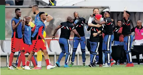  ?? | BACKPAGEPI­X ?? TS Galaxy players and staff celebrate scoring their winning goal against Orlando Pirates on Monday.