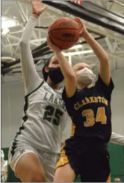  ??  ?? West Bloomfield’s Lola Chambers (25) swoops in to block the shot of Clarkston’s Izzy Hadley (34) in the fourth quarter of the Lakers’ 82-58Senior Night win over the Wolves, completing the season sweep.