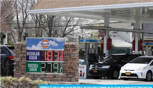  ??  ?? FARMINGDAL­E, NY: Prices for a gallon of gas drop below $2.00 at a Gulf service station in Farmingdal­e, New York. Oil prices rose yesterday after US President Donald Trump said producers are considerin­g cutting 20 million barrels per day - more than double the figure publicly announced-to help the virus - hit sector. —AFP