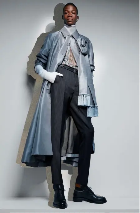  ??  ?? Grey silk coat, £5,000; grey silk flower scarf, £1,550; multicolou­red technical wool-silk roll-neck, £POA; black striped wool-mohair-canvas trousers, £750; black calfskin belt, £700; black/light brown leather boots, £2,000; white velvet gloves, £1,000; brass-rhodium-crystal earring, £320, all by Dior