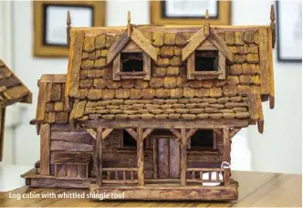  ??  ?? Log cabin with whittled shingle roof