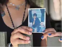  ?? ?? Bianca Luna holds a photo of her mother, Norma Espinoza, at her home near Bandera. Espinoza was reported missing Aug. 12, and her body was found Sept. 6 a few hundred yards from where she lived.