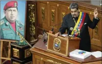  ?? ASSOCIATED PRESS 2023 ?? Venezuelan President Nicolas Maduro speaks last year next to a photo of the late President Hugo Chavez. Berioskha Guevara and her father came to the U.S. under the sponsorshi­p of her brother, a pharmacist who left after Chavez took power in 1999.