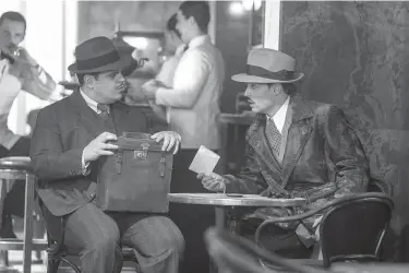  ?? Twentieth Century Fox ?? Josh Gad, left, and Johnny Depp are shown in a scene from "Murder on the Orient Express."