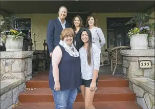  ??  ?? On the house's front porch are current residents Theresa Gallick, left, and her daughter, Zofia. Behind them are former residents Ken Bado, Diana Douglas Shafer and Jackie Douglas.