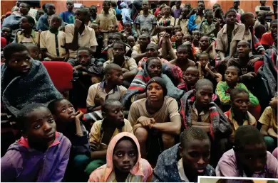  ??  ?? Ordeal ends: Some of the freed schoolboys yesterday. Inset, Michelle Obama with the Bring Back Our Girls slogan in 2014