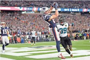  ?? GREG M. COOPER / USA TODAY ?? Patriots receiver Danny Amendola catches a touchdown pass in front of Jaguars safety Tashaun Gipson during the fourth quarter.