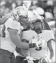  ?? AP/JOSE LUIS MAGANA ?? Central Florida running back Adrian Killins (9) celebrates with teammates after scoring a touchdown Saturday during the No. 20 Knights’ victory over the Navy Midshipmen in Annapolis, Md. Hill led the Knights with 122 yards and 2 touchdowns on 15 carries.