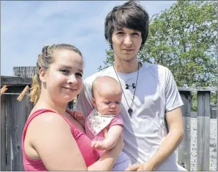  ?? NIKKI SULLIVAN/CAPE BRETON POST ?? Jordan Mcneil, 23, right, stands with his fiancée, Amber Lawrence, 18, and their five-month-old daughter, Lyona Mcneil. The young family has been trying to find an apartment to rent but think they are being rejected because Mcneil is a recovering drug...