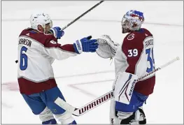  ?? PHOTOS BY MARK ZALESKI — THE ASSOCIATED PRESS ?? Avalanche goaltender Pavel Francouz (39) is congratula­ted by defenseman Erik Johnson (6) after they defeated the Predators in Game 3of a first-round playoff series on Saturday in Nashville, Tenn.