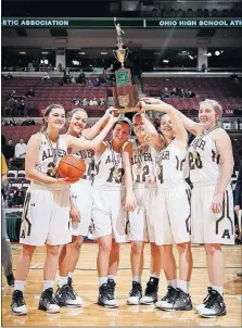  ?? [BARBARA J. PERENIC/DISPATCH] ?? Kettering Alter players hoist their trophy following a 58-41 win over Hathaway Brown.