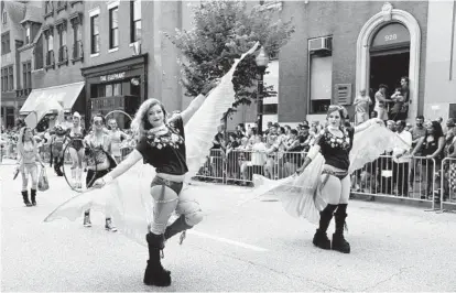  ?? KIM HAIRSTON/BALTIMORE SUN PHOTOS ?? Members of Cosmos Crew march in the Baltimore Pride Parade along Charles Street through Mount Vernon as the Gay & Lesbian Community Center of Baltimore hosts Baltimore Pride 2016.