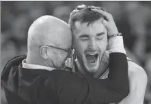  ?? AP ?? UConn head coach Dan Hurley celebrates with forward Alex Karaban after Monday’s victory over Purdue.