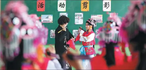  ?? LUO XUEFENG / XINHUA ?? A teacher gives pointers to a pupil during a class on the basics of Peking Opera at a primary school in Longyao county, Hebei province, on Monday. Over the past years, China, under the leadership of the Communist Party of China, has been protecting traditiona­l culture.