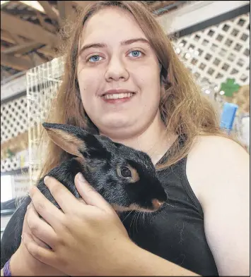  ?? LYNN CURWIN/TRURO NEWS ?? Emma Crossan, a member of the Clifton 4-H Club, showed animals in rabbit, goat, poultry waterfowl at the exhibition. She’s pictured here with Aramis, a five-month-old tan rabbit. and