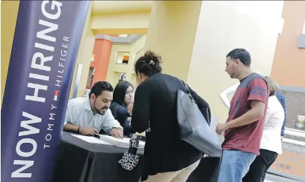  ?? AP PHOTO/ALAN DIAZ/ FILE ?? For all of 2017, U.S. employers added nearly 2.1 million jobs. The country’s unemployme­nt rate remained 4.1 per cent for a third straight month in December, the lowest level since 2000.