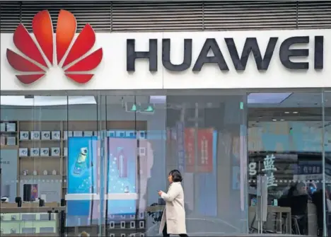  ?? / ALY SONG (REUTERS) ?? Una mujer pasa ante una tienda de Huawei, el jueves pasado en Shanghái.