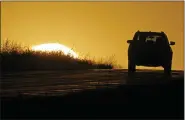  ?? ASSOCIATED PRESS FILE PHOTO ?? A motorist drives into the sunrise in Kansas City, Mo.