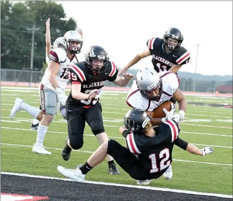  ?? Bud Sullins/Special to Siloam Sunday ?? Siloam Springs senior running back Kevin Canales runs over Pea Ridge’s Jake Adams on his way to the endzone during the Panthers’ scrimmage at Pea Ridge last Tuesday. Pea Ridge defeated Siloam Springs 25-14 in the two-quarter scrimmage.