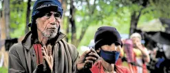  ?? —JIGGER J. JERUSALEM ?? FAR FROM HOME In this photo taken in July 2021, Jobel Maghinay (left) recounts their plight since being driven out of the Manobo-Pulangihon tribe’s ancestral domain in the village of Butong in Quezon, Bukidnon.