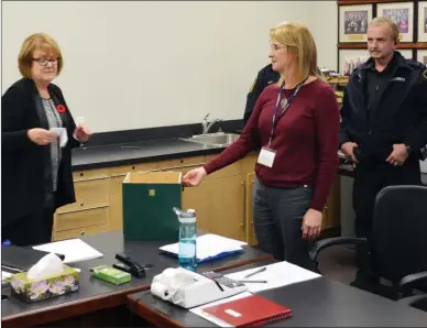  ?? The Daily Courier file photo ?? Election officials in Peachland participat­e in the official recount which ended in the winner being drawn in random.