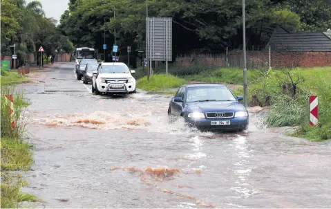  ?? Picture: Deaan Vivier ?? WATERLOGGE­D. Motorists drive over a flooded low-water bridge in Amandalboo­m Street in Pretoria North. Heavy rains in the early hours of Saturday caused some low tide bridges in Pretoria to flood their banks.