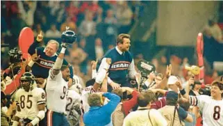  ?? ED WAGNER/CHICAGO TRIBUNE ?? Coach Mike Ditka, center right, and defensive coordinato­r Buddy Ryan celebrate the Bears’ 46-10 win over New England in Super Bowl XX in New Orleans on Jan. 26, 1986.