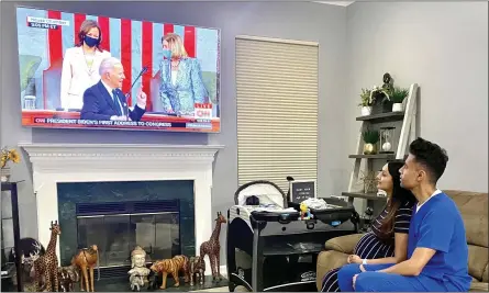  ?? PHOTO COURTESY TWITTER/REPDEAN ?? Dr. Mayank and Payal Amin watch President Joe Biden’s address Wednesday night. Mayank, a pharmacist and owner of Skippack Pharmacy in Schwenksvi­lle, was chosen by U.S. Rep. Madeleine Dean, D-4th. Dist. to virtually attend the speech as her guest.