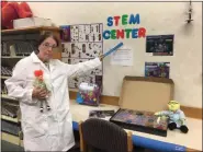  ?? SUBMITTED ?? A Wickliffe Public Library member dons a lab coat as they welcome schoolchil­dren to their new activity-based STEM Center.