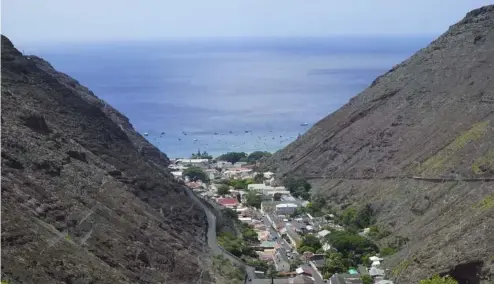  ?? ?? The city of Jamestown is pictured between massive volcanic cliffs on the remote island of St Helena