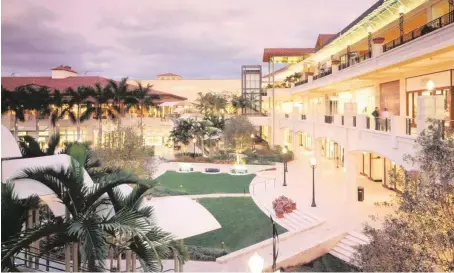  ?? Miami Herald file ?? The Shops at Merrick Park, which includes apartments on one side, was the first new developmen­t built in Coral Gables’ old industrial district, setting the stage for creation of new neighborho­od centered around transit and walkabilit­y.