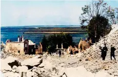  ?? ?? Right: Officers stand among the rubble of Lidice during the demolition of the town’s ruins