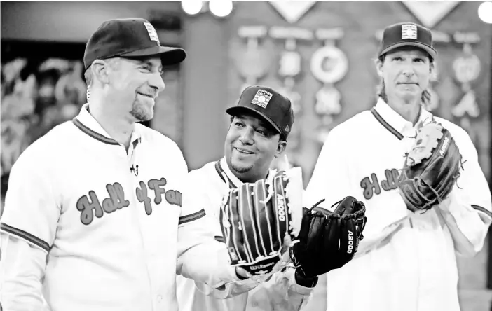  ??  ?? From left, John Smoltz, Pedro Martinez and Randy Johnson form the first trio of pitchers to enter the Hall of Fame together their first time on the ballot.