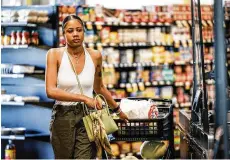  ?? JIM NOELKER / STAFF ?? Gem City Market customer Breelyn Gay shops on Tuesday. This Saturday, Gem City Market will hold a celebratio­n of its first year anniversar­y.