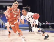  ?? GETTY IMAGES ?? South Carolina’s Zia Cooke drives on Celeste Taylor of Texas during the first half.