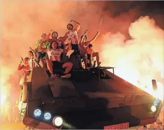  ?? THE ASSOCIATED PRESS ?? Supporters and soccer players of Red Star Belgrade celebrate on top of an armoured troop carrier Tuesday. Croatia has described the parade — and the installati­on of a tank at the stadium — as a provocatio­n.