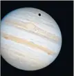  ??  ?? Ganymede casts its giant shadow on to Jupiter’s atmosphere