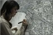  ?? NG HAN GUAN — THE ASSOCIATED PRESS ?? Chinese artist Yang Qian using dots to recreate an aerial view of Wuhan, China, under lockdown at her studio in Wuhan in central China’s Hubei province on Jan. 24.