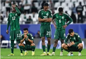  ?? Thekkayil/NurPhoto/REX/Shuttersto­ck ?? Dejection for Saudi Arabia players after their defeat by South Korea. Photograph: Noushad