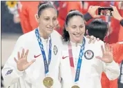  ?? CHARLIE NEIBERGALL — THE ASSOCIATED PRESS ?? Sue Bird, right, and Diana Taurasi pose with their gold medals during the medal ceremony after helping the U.S. beat Japan for another gold medal in women’s basketball.