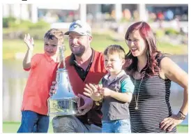  ?? SARAH ESPEDIDO/STAFF PHOTOGRAPH­ER ?? Marc Leishman celebrates his title at the 2017 Arnold Palmer Invitation­al with his wife Audrey, and their two sons Harvey and Oliver.