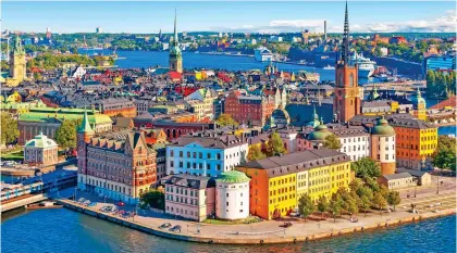  ?? ?? SUNNY OUTLOOK: Stockholm sparkles in the summer. Below: A ride at the Grona Lund amusement park